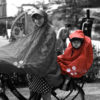 FULAP Jr red riding a bike in the rain with a baby toddler
