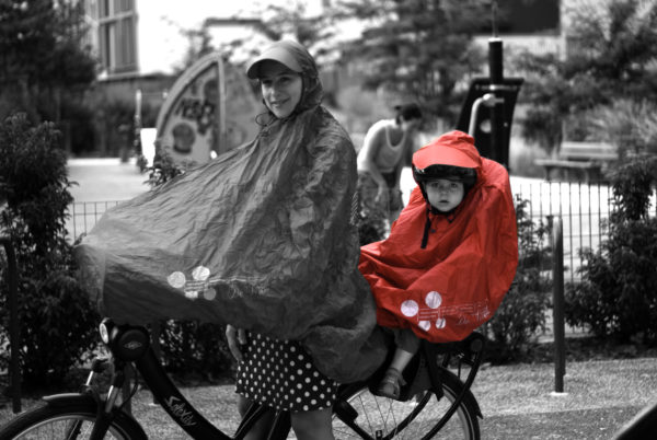 FULAP Jr red riding a bike in the rain with a baby toddler